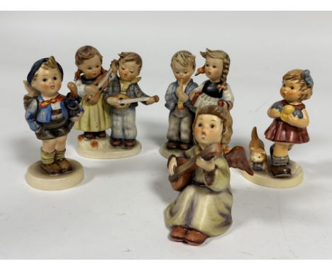 A collection of five German Hummel pottery figures including, Home from Market, Birthday Serenade,Little Knitter, etc. (Talle