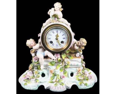 A Meissen Style Mantel Clock:The ceramic case in Meissen style adorned with cherubs and floral detail, the 3 1/2 inch dial in