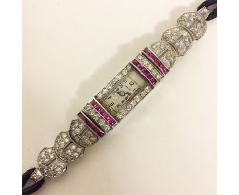 A Platinum, Diamond and Ruby Cocktail Watch CONDITION REPORT: Not currently in working order, winder separate from the stem. 