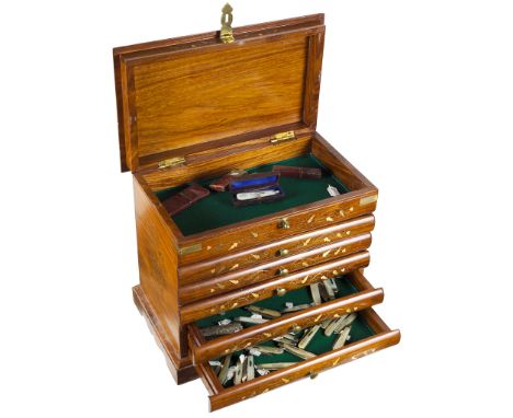 A Small Oriental Five Drawer Display Cabinet Inlaid with Brass Foliage:Containing the following items: Drawer one - forty-six