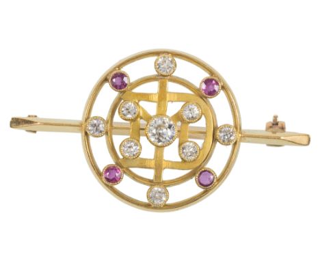 An 18ct Diamond and Ruby Set Bar Brooch:The circular frame set with nine diamonds and four rubies,with applied 18ct hallmark 