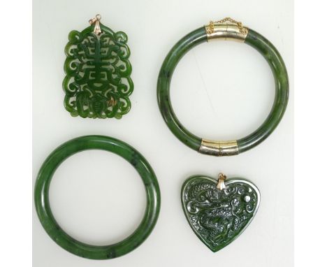 A collection of Jade jewellery including two carved pendants and two bangles (4)
