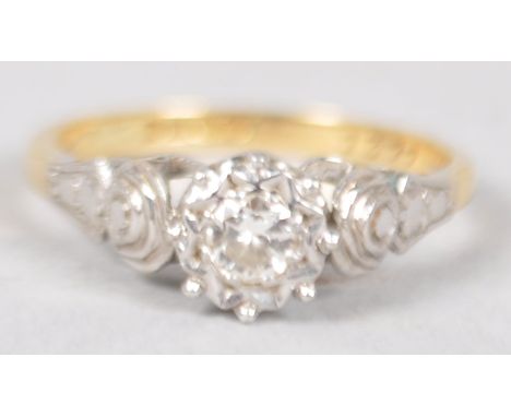 A yellow and white metal ring set with a single round brilliant cut diamond estimated to weigh 0.15cts. Hallmarked 18ct gold,