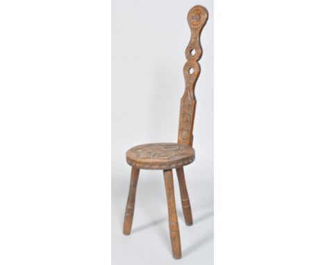 A Carved Ben Setter Totnes Celtic spinning stool, with tall pierced back with foliate rondel, the seat with a six pointed kno