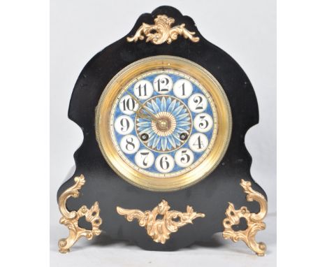 A late 19th century French mantel clock, the ebonised case of scrolled form with gilt metal mounts, the movement with porcela