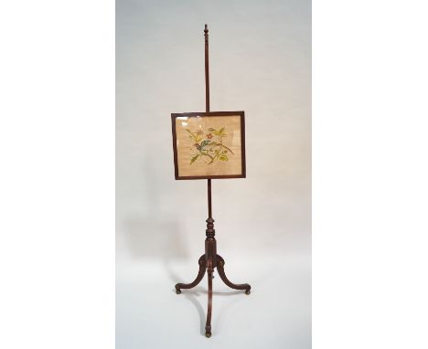An early 19th century mahogany pole screen, the upright topped with a turned baluster urn over a glazed rectangular pane set 