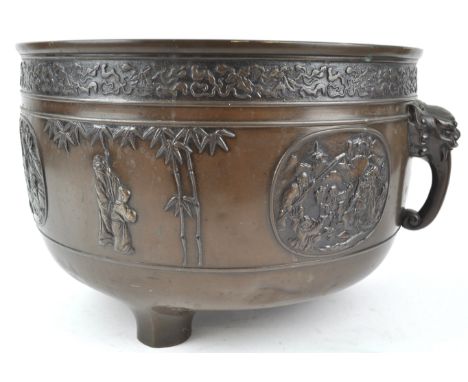 A Chinese bronze tripod incense burner (lacking handles), 16cm high, together with another cast with figures and panels, 21cm