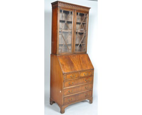 A George III style bureau bookcase with an astragal glazed bookcase above a fall front desk with appointed interior, two over