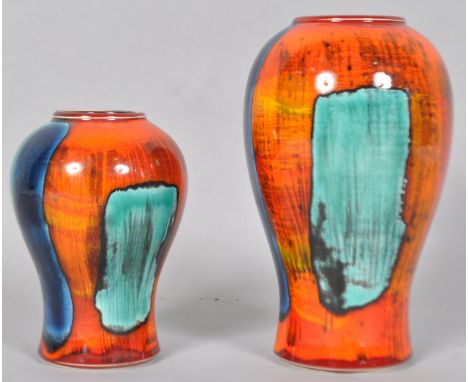 A Poole pottery gemstone vase of baluster form, with typical bright decoration on an orange ground, 19cm high, and another si