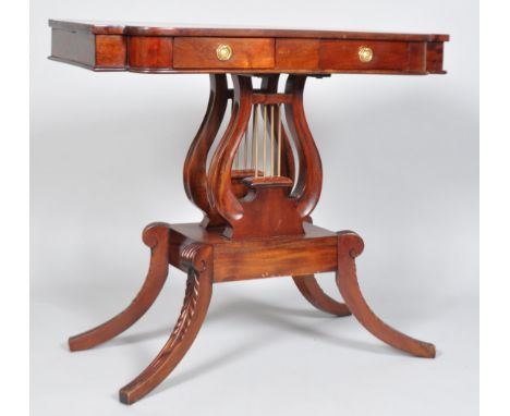 A mahogany lyre style sofa table, in the Regency style, the shaped rectangular top with two short frieze drawers, with brass 