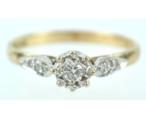 A yellow and white metal single stone ring set with round brilliant cut diamond of approximately 0.08cts and finished with di