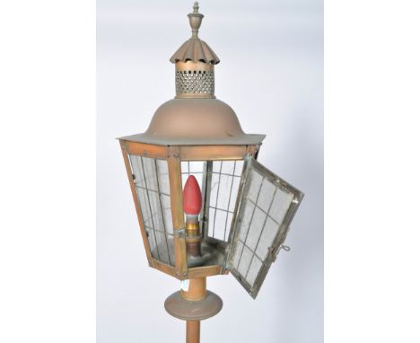 A brass standard lamp, with glass lantern shaped top, 174cm high