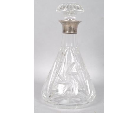 A cut glass decanter and stopper with silver collar, hallmarked London 1962, 26.5cm high
