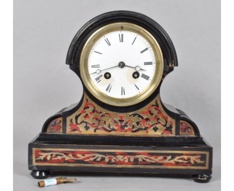 A late 19th century mantel clock, of arched rectangular form, with enamelled dial and roman numerals, the ebonised case inlai