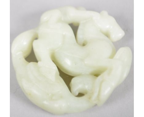 A pale celadon jade carving of a monkey riding a horse above a stylised dragon