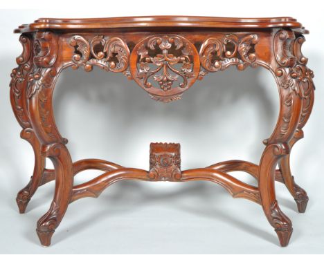 A reproduction mahogany console table with pierced carved details on cabriole legs, 80cm high, 118cm wide, 44cm deep