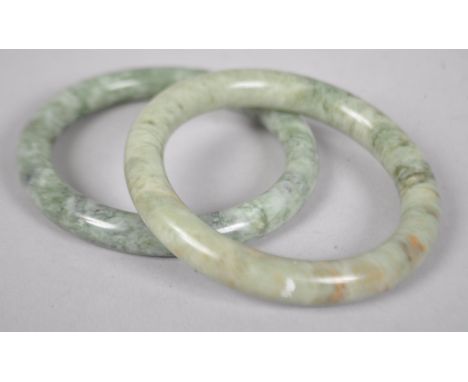 A pair of mottled jade bangles