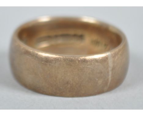 A yellow metal 7.5mm D shape wedding ring. Hallmarked 9ct gold, Birmingham, 1959. Size: N (Leading edge) 6.8 grams