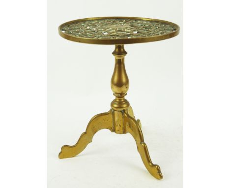 A 19th century brass trivet in the form of a tripod table with baluster stem and pierced top, 26cm high x 22cm diameter