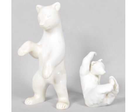 A pair of KPM Berlin porcelain clear glazed ceramic bears one in a seated postion and the other standing, both marked on the 