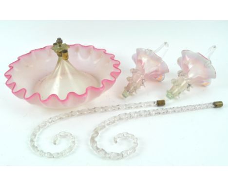 A Victorian glass epergne, the circular frilled base with pink rim, issuing two clear twisted branches, suspending two pink b
