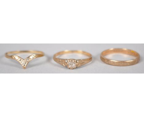 A collection of three rings to include: A hallmarked 9ct gold 2.5mm wedding ring, size L; A hallmarked 9ct gold wishbone ring