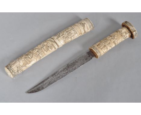 An Oriental Tauto the bone scabbard and grip carved with a cascade of figures, blade 18.5cm long, overall 40cm long