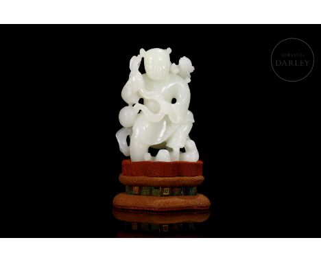 Beautiful carved white jade. It shows, with a composition full of movement, the image of a small young boy, with his hair tie