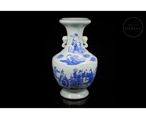 This ceramic vase is decorated with a light, celadon-coloured glaze on which a large scene in white and cobalt-blue tones sta