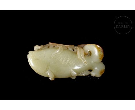 Carved jade figure of light tonality, slightly greenish, with reddish spots. It shows in detail, the image of a large fish wi