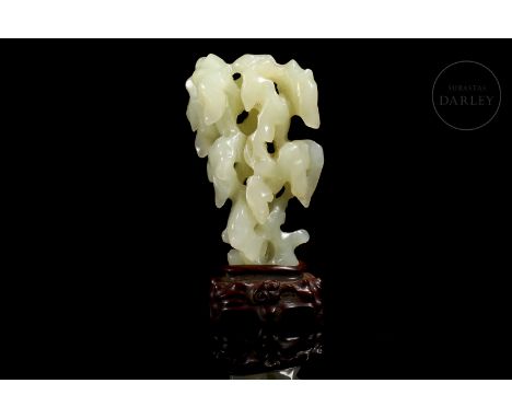 Beautifully carved jade imitating the natural shape of a tall, craggy Taihu ‘太湖石’ stone. It stands out for the verticality of