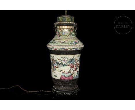 Polychrome glazed ceramic vase with later adaptation to a lamp. It has a circular base and a narrow foot that grows to the he