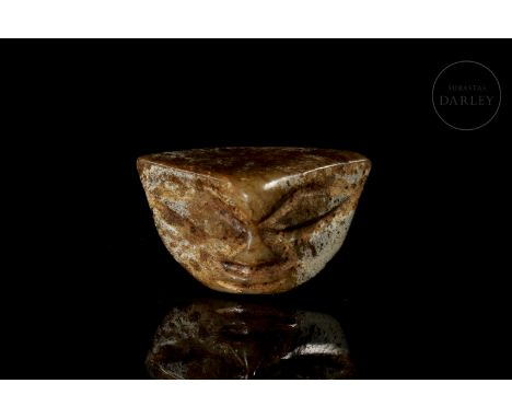 Small carved jade image. Covered in patina produced by ageing, with a reddish-brown colour that contrasts with patches of whi