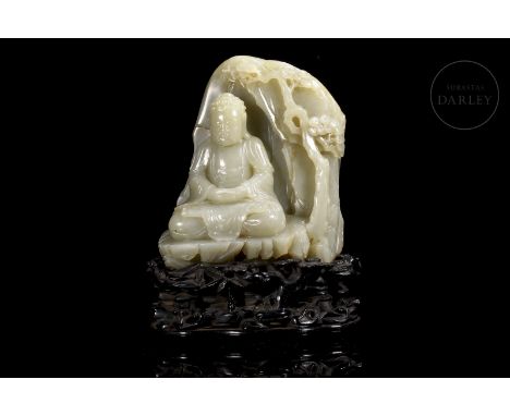 Carved Hetian jade, light tonality with slight ochre stains. It shows the figure of Buddha, seated with his legs in lotus pos