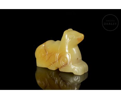 Beautiful yellow jade with light streaks of reddish and golden tonality. It shows, in an archaic-style representation, the im