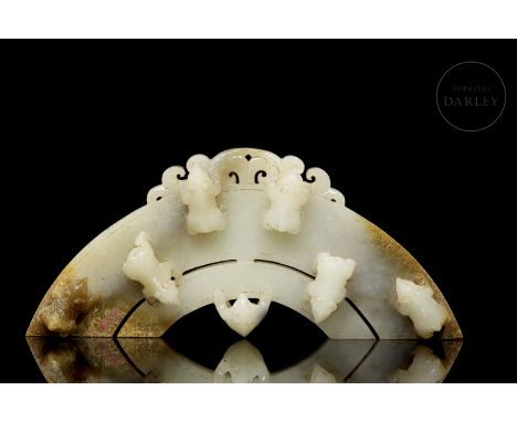 Carved white jade pendant, with ochre and brownish spots. It has the shape of a fan or half ellipse, with two bodies of diffe