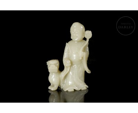 A carved jade figure with a light, off-white hue. It shows an upright Luohan, holding in his hands ritual items such as a lon