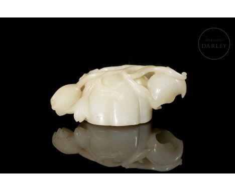 A light-coloured carved jade vessel with subtle amber flecks. It has a lobed, rounded, hollow central body that mimics the na