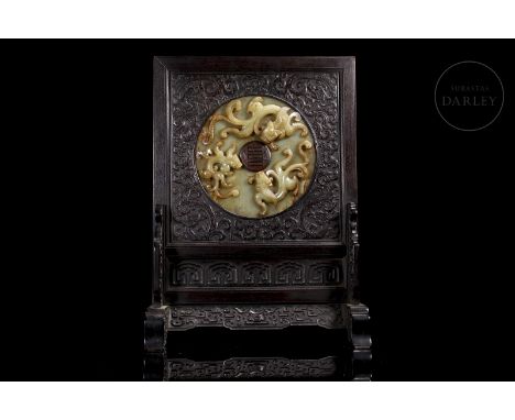 Rectangular carved wooden panel, supported on two wide feet. It is profusely decorated on both sides with reliefs whose subje