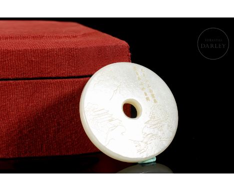 Hetian white jade disk carved in the shape of a “Bi”, decorated with incised details. It shows, on the front side, a beautifu