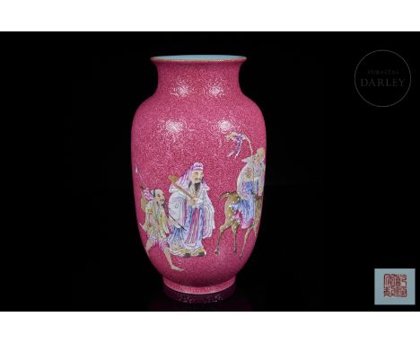 Porcelain vase arranged on a short circular foot, has a slightly elongated oval body that narrows slightly in the wide neck a