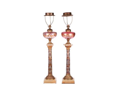 A pair of 19th-century French onyx, gilt metal and champléve enamel oil lamp bases of Corinthian column form with slightly di