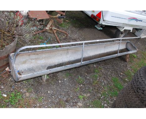 A sheep trough, 9' long with wheels to one end.