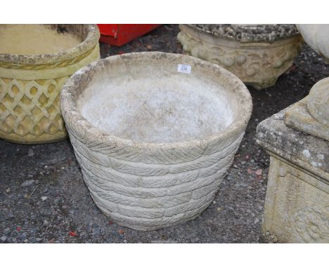 A concrete round planter, 19 1/2" wide x 12 1/2" deep.