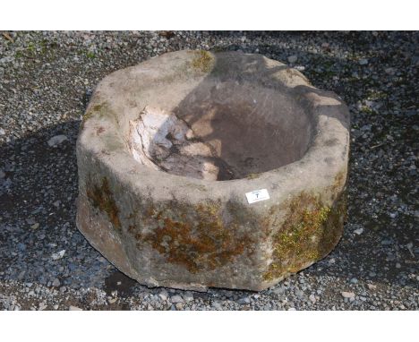 A shaped stone planter, 20" diameter x 10" deep.