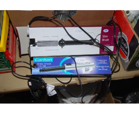 A pair of electric hair stylers, a "Boots" slim brush and a "Carlton" electric styler HC500.