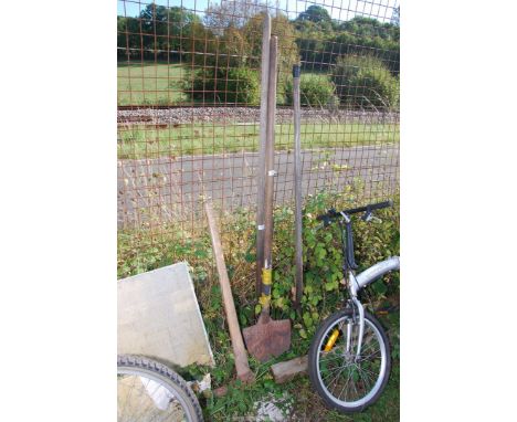 Two long armed forks, a turfing spade and a pick axe.