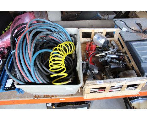 A crate containing a large quantity of pneumatic air tools to include: air pop riveter, oil spray gun, 1/2" drive air wrench,