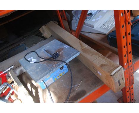 A 240 volt tile cutter and a projector screen.