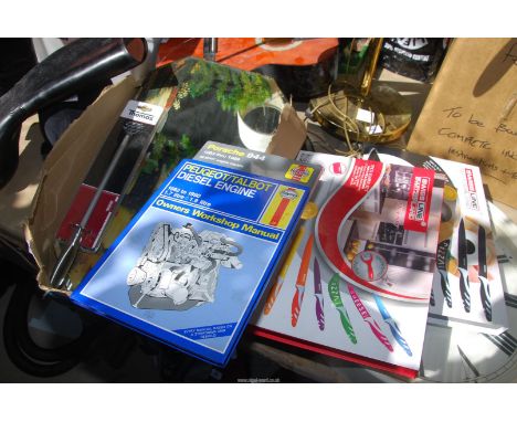 A Haines manual, a Porsche 944 manual, a mirror, and three knife sets.